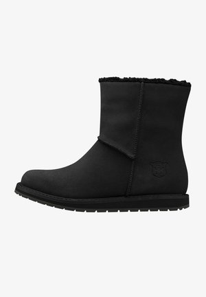 Botas negras hasta el tobillo hechas de un material similar ante con un forro suave y peludo. Presentan una punta redonda, costuras cosidas y una suela de goma texturizada.