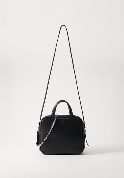 Black leather bag with a square shape, dual handles, and an adjustable chain strap. Features a smooth texture and subtle branding on the front.