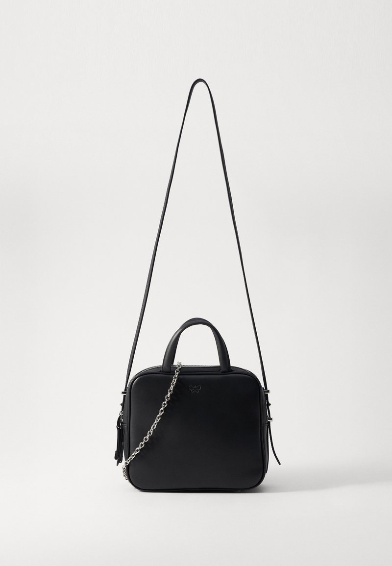 Must mustrakk mustrauk, kahe käepidame ja reguleeritava kettrihmaga. Omab sujuvat tekstuuri ja diskreetset brändingut ees.