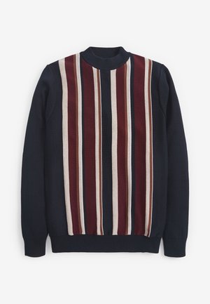 Granatowy sweter z pionowymi paskami w kolorach bordowym, beżowym i brązowym pośrodku z przodu, wyposażony w prążkowany półgolf i mankiety.