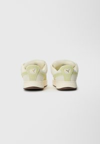 White and light green sneakers with a suede and synthetic upper, padded collar, and small gold branding on the heel. Rubber outsole.
