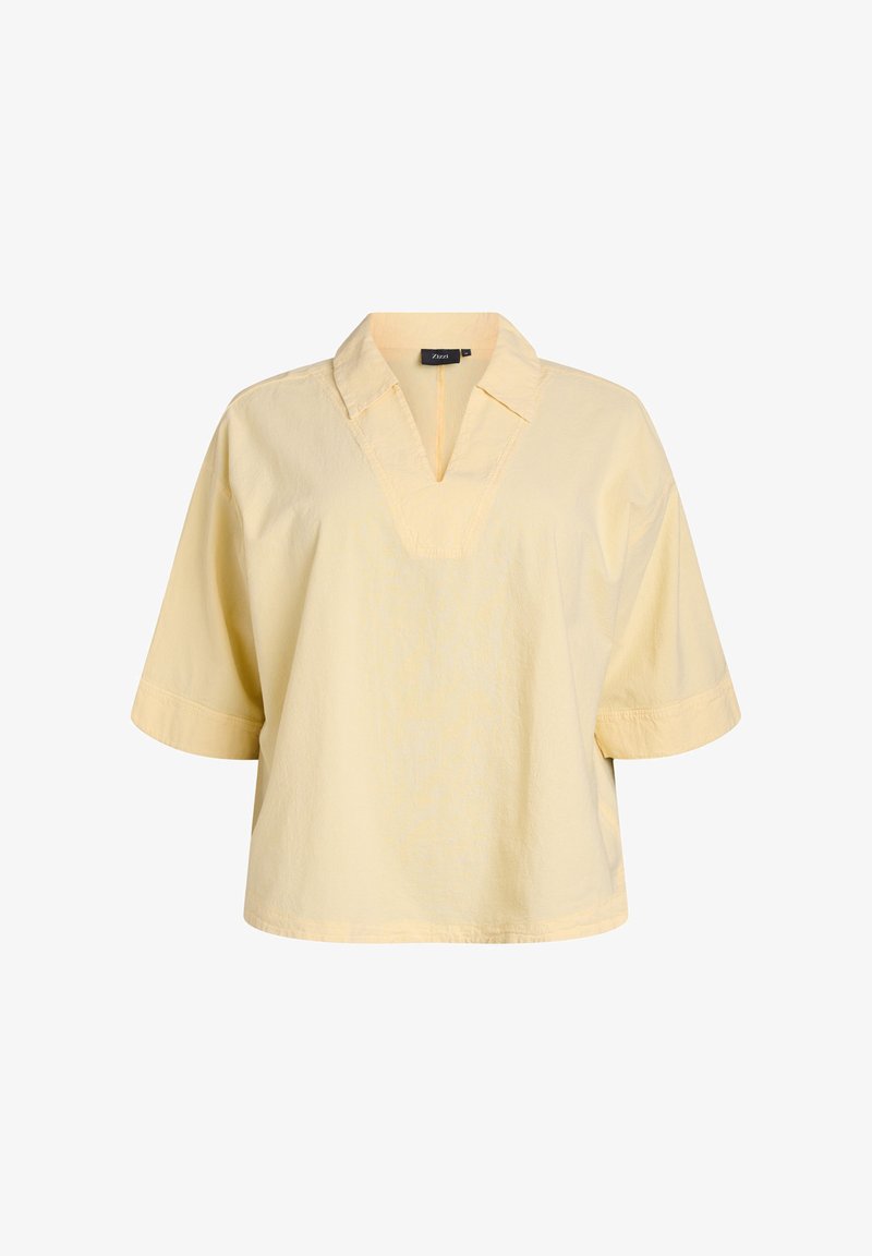 Hellgelbe Kurzarmbluse mit V-Ausschnitt, lockerer Passform und strukturiertem Stoff. Mit umgeschlagenen Ärmeln und einem sauberen Saum.