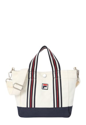 Piccola borsa a mano bianca e blu navy con manici a strisce rosse e nere e una toppa con logo sulla parte anteriore, dotata di tracolla removibile.