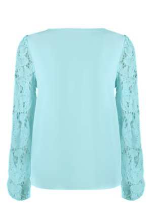 Un chemisier bleu sarcelle clair avec des manches longues en dentelle, présentant un corps en tissu lisse et des motifs délicats de dentelle florale sur les manches.