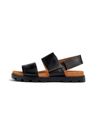 Black leather sandals with two wide straps and a tan footbed. Features a sturdy black rubber sole with a textured pattern for grip.
