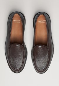 Ciemnobrązowe skórzane loafersy z teksturowaną cholewką, zaokrąglonym noskiem i subtelnymi detalami przeszyć, wyposażone w gładką wewnętrzną wyściółkę.