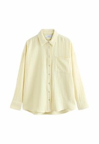 Light yellow shirt with a textured pattern, button front, collar, and long sleeves. Features a single chest pocket and a relaxed fit.