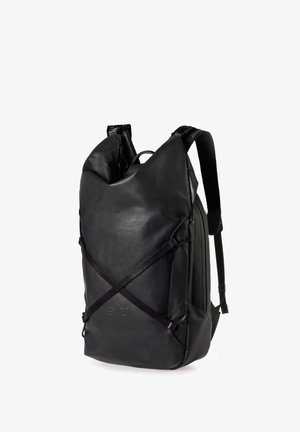 Black leather backpack with a roll-top design, adjustable shoulder straps, and an exterior cross strap. Features a smooth texture and minimal branding.