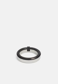 Metal ring featuring a shiny silver inner band and a matte black outer band, with a small accent at the center. Smooth texture, circular shape.
