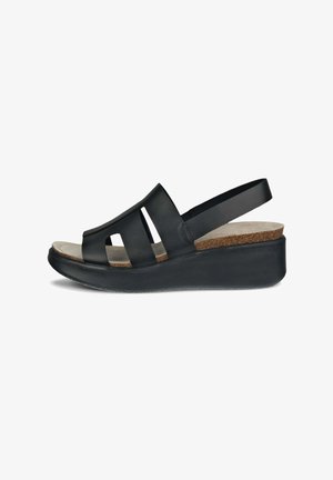 Sandalo a zeppa nera con design a intaglio. Presenta una soletta in sughero, una cinghia regolabile e una tomaia in pelle liscia. Suola in gomma per una migliore aderenza.