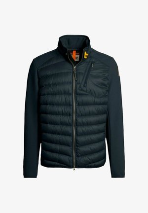 Veste matelassée bleu marine avec un col montant, fermeture éclair à l'avant et manches texturées. Comprend un accent jaune, des poches latérales et une coupe ajustée.
