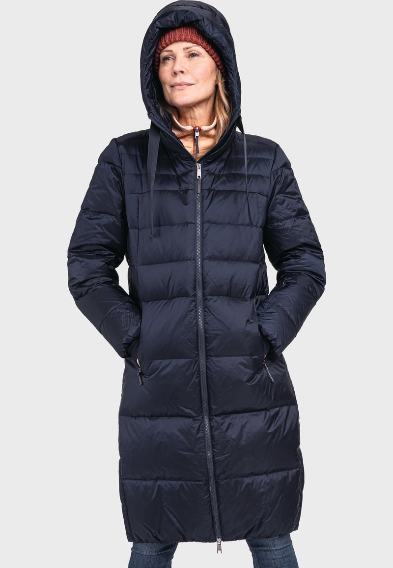 Marineblaue Daunenjacke mit Kapuze, ausgestattet mit einem Reißverschluss, zwei seitlichen Taschen und gestepptem Muster zur Isolierung. Leicht und schlank im Design.