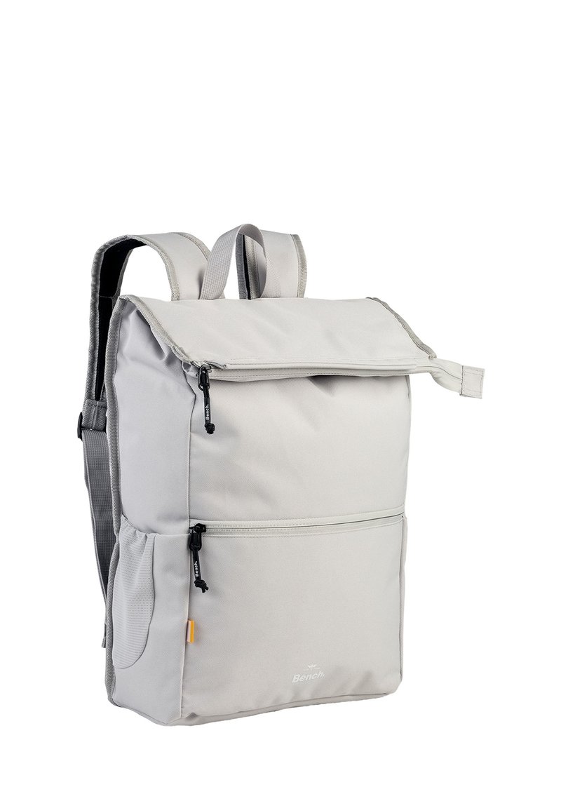 Grau farbener Stoff-Rucksack mit zwei verstellbaren Trägern, einem Reißverschluss-Frontfach und einer oberen Klappverschluss. Verfügt über ein Logo auf der Vorderseite.