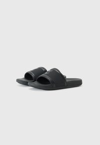 Black rubber slides with two wide straps, textured footbed, and a smooth finish. Features a subtle logo on top of each strap.