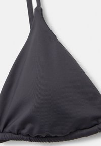 Top de bikini gri închis cu cupe triunghiulare, curele subțiri ajustabile și detalii pliate de-a lungul bazei pentru o potrivire strânsă. Textură de material neted.
