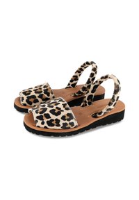 Leopard print slingback sandals with a flat sole, leather insole, and soft fabric upper. Features a wide toe strap and thin ankle straps.