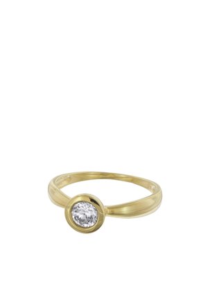 Gold ring with a single round clear gemstone set in a smooth bezel setting on a plain band.