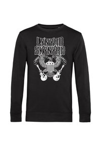 T-shirt a maniche lunghe nera con stampa bianca "LYNYRD SKYNYRD" e una grafica con un'aquila, stelle e due chitarre. Materiale in cotone, collo tondo.