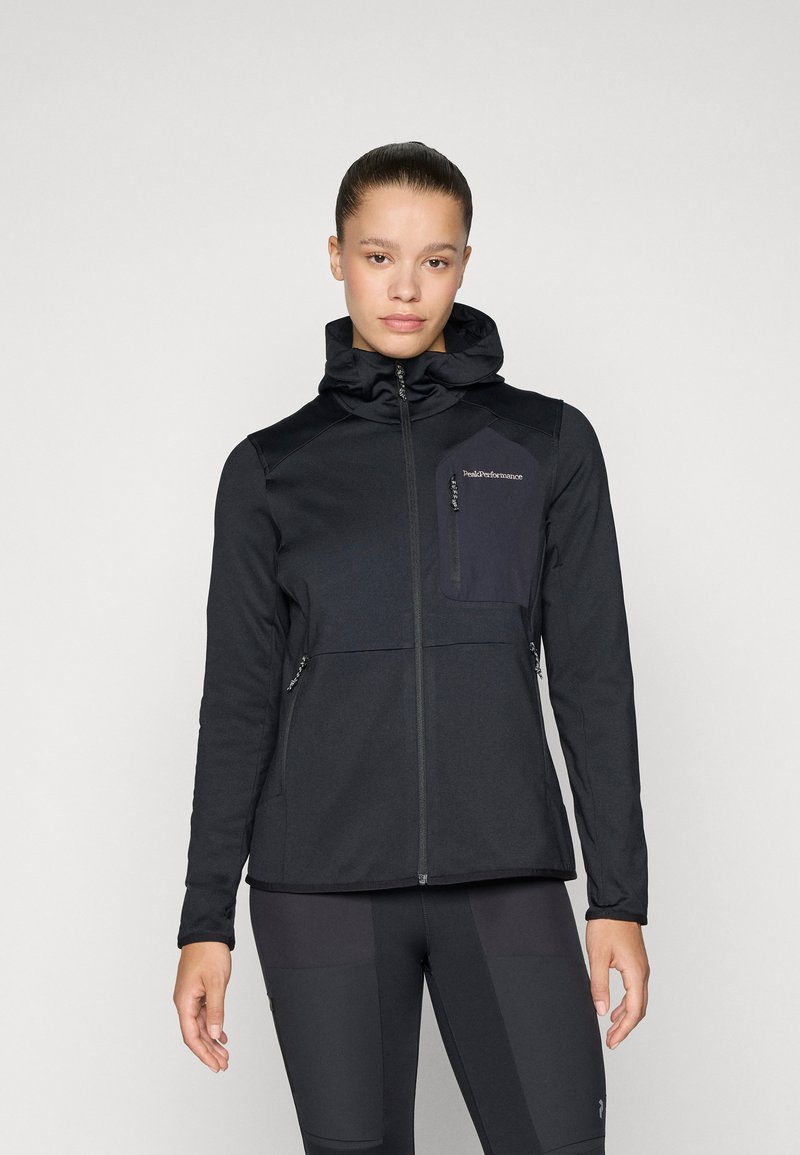Black softshell jacket with a hood, featuring a zippered front, side pockets, and a contrasting pocket detail on the chest.
