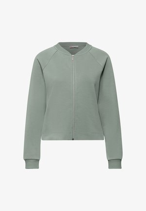 Ljusgrön zip-up-tröja med långa ärmar, ribbade muddar och krage samt en liten märkesetikett inuti kragen.