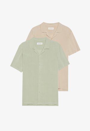 Short-sleeve button-up shirts in pastel green and beige, featuring a lightweight fabric, relaxed fit, and a camp collar design.