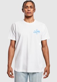 White cotton t-shirt with short sleeves, featuring “The Pasta Lover Club” in blue text on the left chest, and relaxed fit.