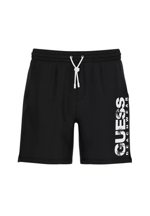 Costume da bagno nero con coulisse bianca e scritta "GUESS BEACHWEAR" stampata verticalmente sulla gamba destra con motivo di palma.