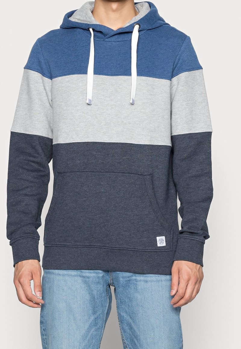 Grijze hoodie met blauwe en marine strepen. Heeft een voorkeurszak en witte trekkoorden. Gemaakt van zachte, gestructureerde stof.