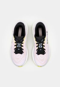 Running shoes with a light pink mesh upper, black accents, yellow detail, and black laces. Cushioning sole and logo on the side.