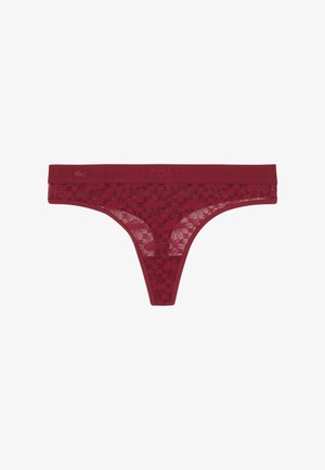 Tanga de encaje rojo con patrón floral y cintura elástica con el logo en relieve de Lacoste y pequeño emblema de cocodrilo.