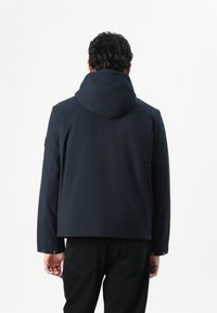Námořnická modrá bunda s kapucí, vyrobená z hladké látky. Má dlouhé rukávy a stříbrné patentky na manžetách. Jednoduchý a elegantní design.