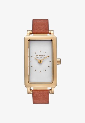 Reloj Skagen rectangular en tono dorado con esfera blanca minimalista y correa de cuero marrón, mostrando la hora 10:10.