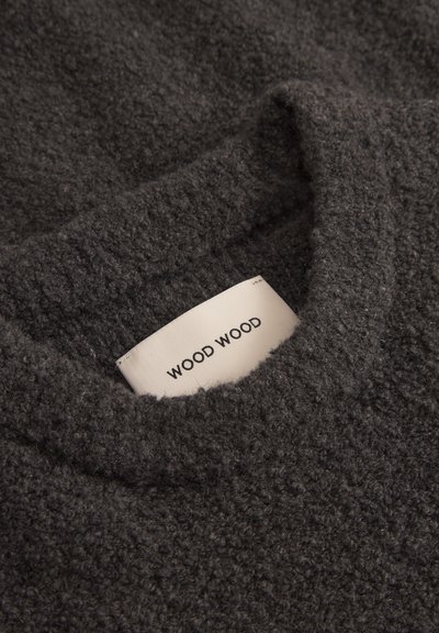 Siv svetrov z teksturo in visokim ovratnikom ter vidno oznako blagovne znamke "WOOD WOOD." Tkanina se zdi mehka in puhasta.