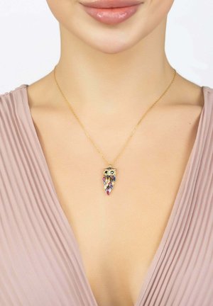 Gold owl pendant necklace with colorful gemstones, featuring two round eyes and a multicolored teardrop design. Chain is delicate and fine.