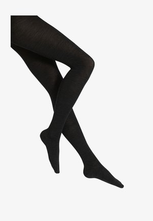 Schwarze, blickdichte Strumpfhosen mit glatter Textur, figurbetontem Design und verstärkter Zehenpartie, die einen nahtlosen Look von der Taille bis zum Fuß präsentieren.