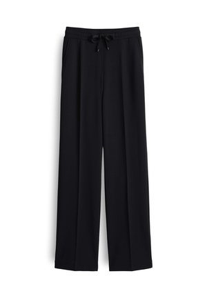 Zwarte wijde broek van zacht materiaal, met een elastische tailleband, verstelbare trekkoord en zijzakken.