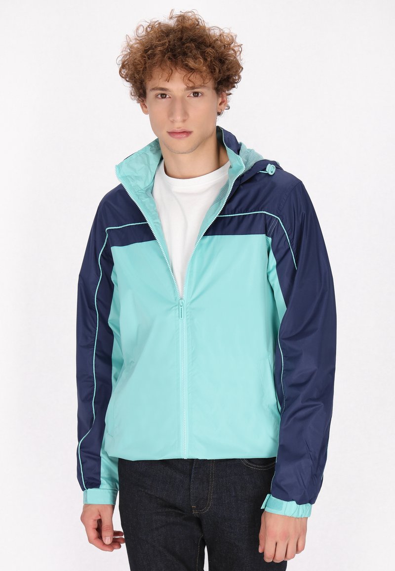 Lichtgewicht, zip-up jas in turquoise en marineblauw kleurblok. Voorzien van een capuchon, elastische manchetten en ademend materiaal met contrasterende stiksels.