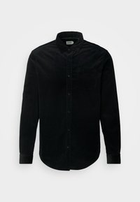 Camicia nera di velluto a coste con maniche lunghe, davanti con bottoni, colletto e taschino singolo sul petto. Tessuto strutturato in un design classico.