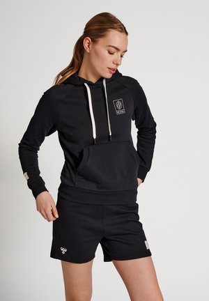 Black hoodie with a front pocket and white drawstrings, paired with black shorts. Features a logo on the chest and a textured fabric.