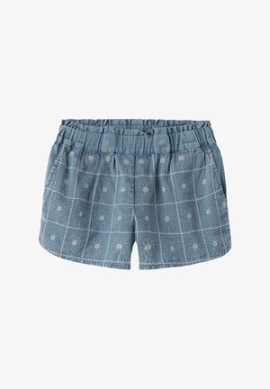 Kék farmer rövidnadrág rugalmas derékpánttal, elülső zsebekkel és fehér, hímzett margaréta mintákkal, amelyek rács formában helyezkednek el a szöveten.