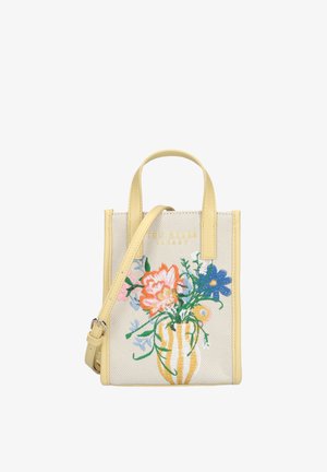 Petit sac fourre-tout beige avec bordure jaune, fleurs colorées brodées dans un vase rayé, et bandoulière ajustable.