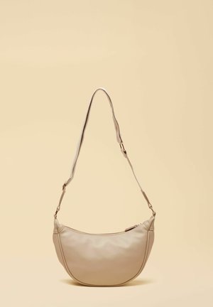 Beige leather shoulder bag with adjustable strap and zipper closure, displayed against a light beige background.