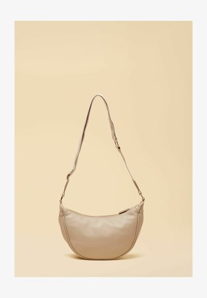 Beige leather shoulder bag with adjustable strap and zipper closure, displayed against a light beige background.