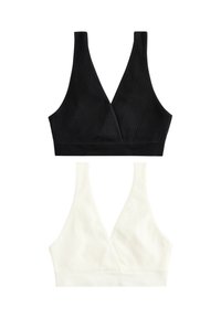 To bh'er i sort og creme, med ribbet struktur, V-udskæring og brede skulderstropper. Hver har en sømløs kant forneden.