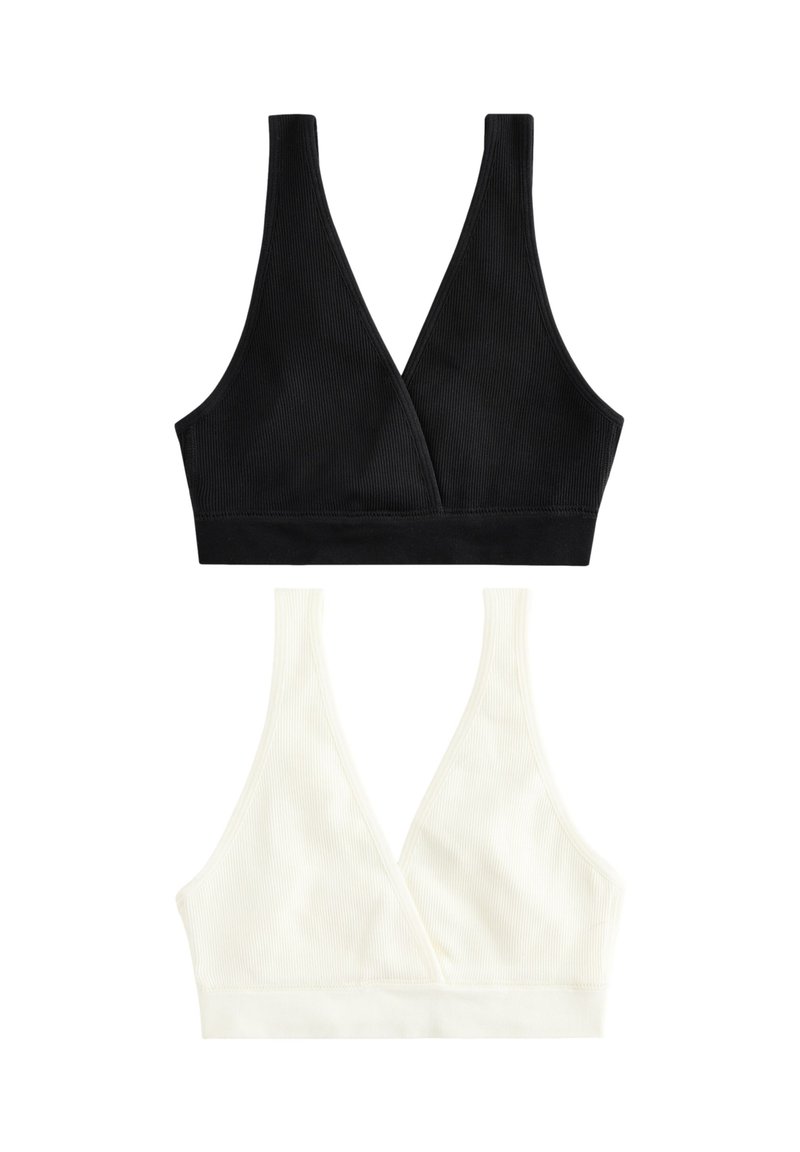 To bh'er i sort og creme, med ribbet struktur, V-udskæring og brede skulderstropper. Hver har en sømløs kant forneden.