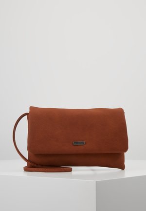 Soft textured brown leather clutch bag with a fold-over flap and a slender wrist strap sitting on a white pedestal.