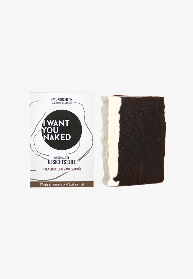 Brązowe i białe marmurowe mydło w kostce obok prostokątnego pudełka, charakteryzującego się minimalistycznym wzornictwem z czarnym tekstem i naturalnym brandingiem kosmetycznym.