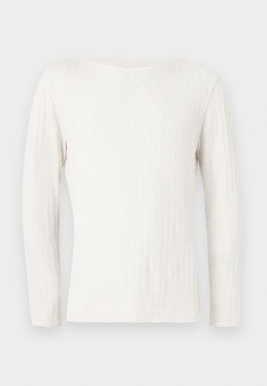 Λευκό ριμπ πλεκτό πουλόβερ με μακριά μανίκια και στρογγυλή λαιμόκοψη, απλωμένο σε επίπεδη επιφάνεια πάνω σε ανοιχτό γκρι φόντο.