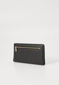 Black leather wallet with a textured finish, featuring a gold metal zipper on the front and a sleek, rectangular shape.