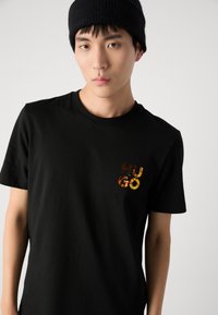 HUGO DIRIDUMTI - T-shirt - bas - black